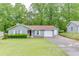 Charming one-story home with well-maintained lawn, attached garage, and mature trees at 376 Paula Ct, Lawrenceville, GA 30046