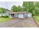 Single-story home featuring a large driveway leading to both an attached and detached garage at 376 Paula Ct, Lawrenceville, GA 30046