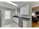 Eat-in kitchen featuring stainless steel appliances and adjacent view into the living room at 376 Paula Ct, Lawrenceville, GA 30046