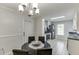 Eat-in kitchen features stainless appliances, white cabinetry and a modern light fixture above the dining table at 376 Paula Ct, Lawrenceville, GA 30046