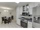 Eat-in kitchen with stainless appliances and abundant white cabinetry at 376 Paula Ct, Lawrenceville, GA 30046