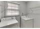 Dedicated laundry area featuring a washing machine, dryer and wire shelving at 376 Paula Ct, Lawrenceville, GA 30046