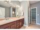 Double vanity bathroom with a large mirror and modern fixtures and dark wood cabinets at 3807 Cyrus Ridge Nw Way, Kennesaw, GA 30152