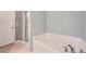 Bright bathroom featuring a soaking tub with chrome fixtures and a glass-enclosed shower at 3807 Cyrus Ridge Nw Way, Kennesaw, GA 30152