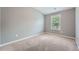Neutral bedroom featuring plush carpeting, light gray paint, and a window to bring in natural light at 3807 Cyrus Ridge Nw Way, Kennesaw, GA 30152