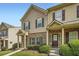 Attractive townhome with covered entryway, brick accents, and professionally landscaped front yard at 3807 Cyrus Ridge Nw Way, Kennesaw, GA 30152