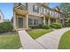 Inviting townhouse exterior with covered porch, brick facade, and meticulously maintained green spaces at 3807 Cyrus Ridge Nw Way, Kennesaw, GA 30152