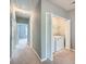 Upstairs hallway with bi-fold doors to laundry and view of carpeted bedrooms, painted in light gray at 3807 Cyrus Ridge Nw Way, Kennesaw, GA 30152