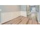 Hallway with decorative wainscoting, new floors, and access to the home's entrance at 3807 Cyrus Ridge Nw Way, Kennesaw, GA 30152