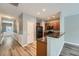 Hallway leading to the kitchen with wood floors and white wainscoting at 3807 Cyrus Ridge Nw Way, Kennesaw, GA 30152