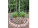 Landscaped backyard with a small fountain, flowers, and greenery at 4056 Kingsley Park Ct, Peachtree Corners, GA 30096