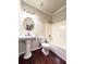 Bathroom with pedestal sink, shower, and hardwood floors at 4056 Kingsley Park Ct, Peachtree Corners, GA 30096