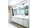 Bathroom featuring a double vanity, large mirror, and a view of the tub and shower through the mirror's reflection at 4056 Kingsley Park Ct, Peachtree Corners, GA 30096