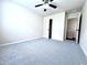 Bedroom with gray carpet, neutral walls, ceiling fan, and a door leading to a closet at 4056 Kingsley Park Ct, Peachtree Corners, GA 30096