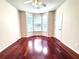 Cozy bedroom featuring large bay window, beautiful hardwood floors, and neutral decor at 4056 Kingsley Park Ct, Peachtree Corners, GA 30096