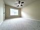 Bright bedroom features new carpet, ceiling fan, and a large window at 4056 Kingsley Park Ct, Peachtree Corners, GA 30096