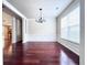 Classic dining room with hardwood floors, wainscoting, and a large window offering natural light at 4056 Kingsley Park Ct, Peachtree Corners, GA 30096