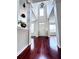 Bright foyer with hardwood floors, soaring ceilings, elegant lighting, and white columns creating a grand entrance at 4056 Kingsley Park Ct, Peachtree Corners, GA 30096