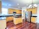 Bright kitchen boasts stainless steel appliances, black countertops, and hardwood floors at 4056 Kingsley Park Ct, Peachtree Corners, GA 30096
