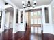 Inviting living room featuring hardwood floors, white columns, fireplace, and lots of natural light from large windows at 4056 Kingsley Park Ct, Peachtree Corners, GA 30096