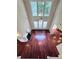 View from the staircase into the living room with hardwood floors, high ceilings and large windows at 4056 Kingsley Park Ct, Peachtree Corners, GA 30096