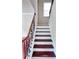 Elegant staircase featuring dark wood treads, white risers, and an ornate iron railing, illuminated by a window at 4056 Kingsley Park Ct, Peachtree Corners, GA 30096