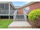 Exterior steps leading to the back deck with lush landscaping, creating a seamless transition to outdoor living at 516 Main St, Hiram, GA 30141