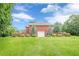 Charming brick home with a lush green lawn, privacy wall, and attached garage at 516 Main St, Hiram, GA 30141