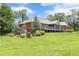 Stunning backyard view showcasing a brick home with a screened-in porch and well-maintained landscaping at 516 Main St, Hiram, GA 30141