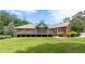 A brick house featuring a large screened porch and sprawling backyard lawn at 516 Main St, Hiram, GA 30141