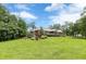 Expansive backyard featuring a beautiful brick home, large trees, and lush green grass at 516 Main St, Hiram, GA 30141