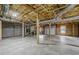 Unfinished basement with concrete floor, exposed ceiling and wooden support beams at 516 Main St, Hiram, GA 30141