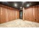 Basement room with carpeted floors, wood walls and exit to outside at 516 Main St, Hiram, GA 30141