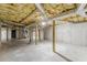Large unfinished basement space with exposed beams and cement flooring, ready to be renovated at 516 Main St, Hiram, GA 30141