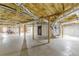 Spacious unfinished basement with wood beams and cement flooring, and a side entry door at 516 Main St, Hiram, GA 30141