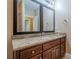 Bathroom vanity with granite countertop and dark wood cabinets at 516 Main St, Hiram, GA 30141