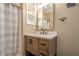 Charming bathroom with custom vanity, decorative mirror, and shower with curtain at 516 Main St, Hiram, GA 30141