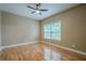 Bedroom with a ceiling fan, hardwood flooring, and a large window at 516 Main St, Hiram, GA 30141