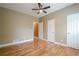 Bedroom with hardwood flooring, ceiling fan, and access to additional rooms at 516 Main St, Hiram, GA 30141