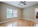 Bedroom featuring hardwood floors, a ceiling fan, and large window at 516 Main St, Hiram, GA 30141