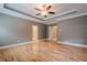 Spacious bedroom with a ceiling fan, wood floors, and tray ceiling at 516 Main St, Hiram, GA 30141