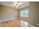 Bright bedroom with hardwood floors, a ceiling fan, and large window at 516 Main St, Hiram, GA 30141