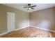 Bedroom featuring hardwood floors, a ceiling fan, and ample space, ensuring comfort at 516 Main St, Hiram, GA 30141