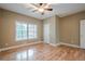 Inviting bedroom with hardwood floors, large window, and neutral color palette at 516 Main St, Hiram, GA 30141