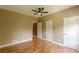 Bedroom featuring hardwood floors, ceiling fan, and dual closets, perfect for storage at 516 Main St, Hiram, GA 30141