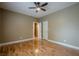 Bedroom with hardwood floors, ceiling fan, and doorway to another room at 516 Main St, Hiram, GA 30141