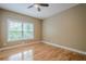 Bedroom with hardwood floors, large window, and natural lighting at 516 Main St, Hiram, GA 30141