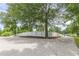 Long driveway leading to a property bordered by a white fence and mature trees at 516 Main St, Hiram, GA 30141