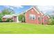 Well-maintained single-story brick home featuring a lush green lawn and tidy landscaping at 516 Main St, Hiram, GA 30141