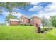 Lovely brick home with lush landscaping, round shrubs, and green grass at 516 Main St, Hiram, GA 30141